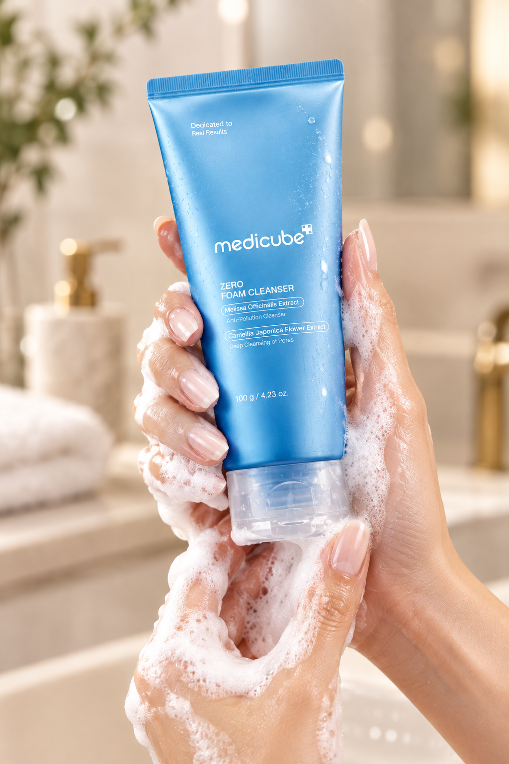 Medicube Zero Foam Cleanser held in hands with foam lather lifestyle shot